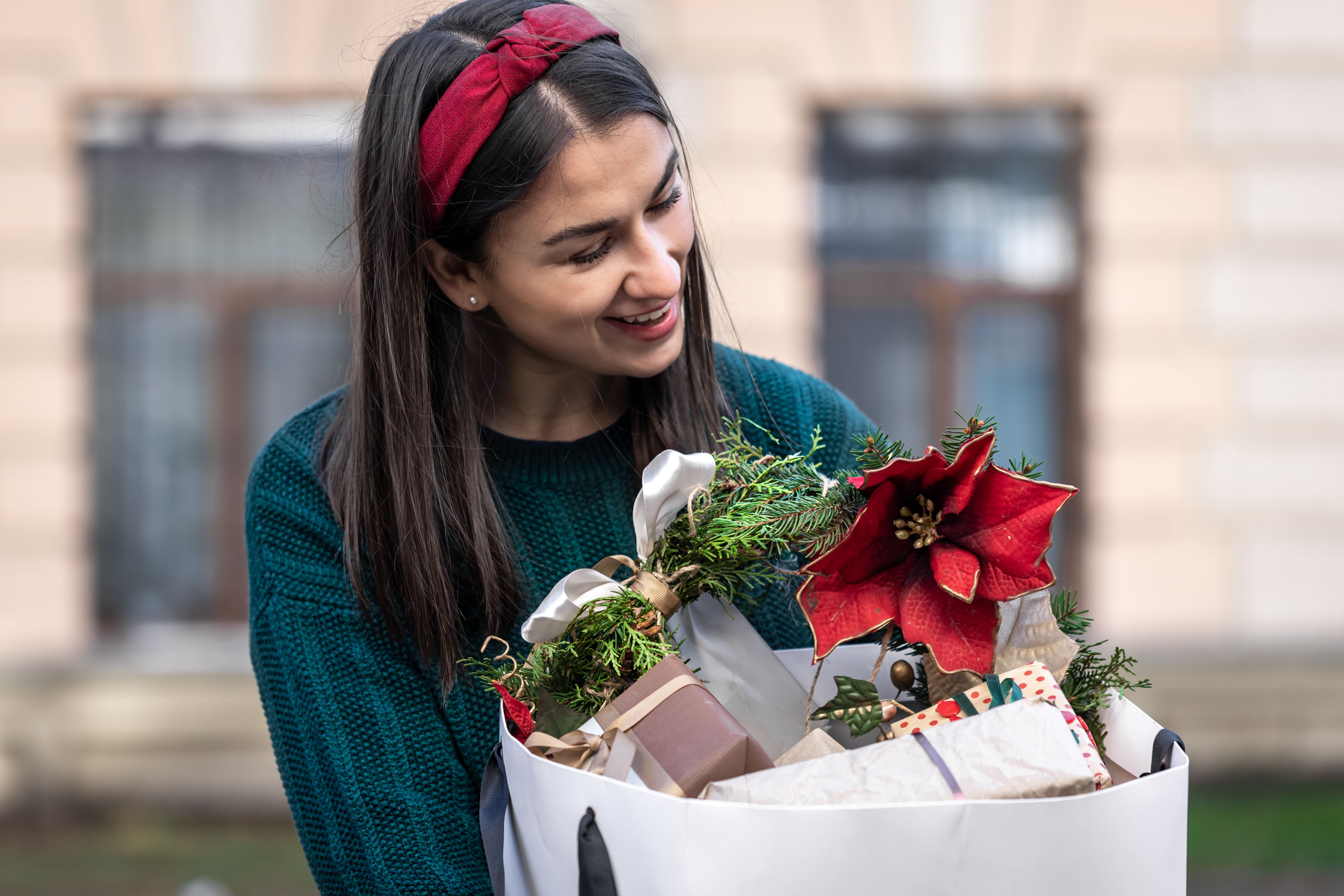 young-woman-with-christmas-gifts-outside-christmas-shopping.jpg